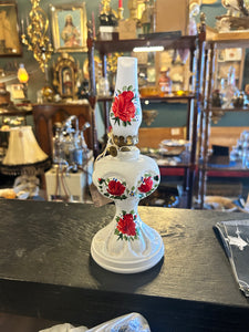 White oil lamp with red flowers